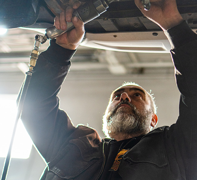 Gary Fonseca working under a car at Fonseca Auto and Transmission